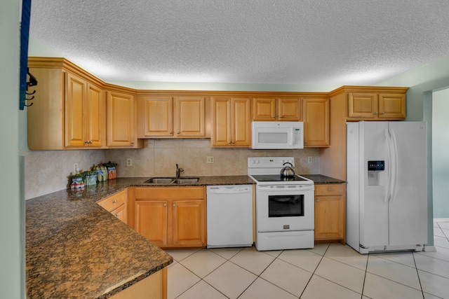 kitchen featuring white appliances, light tile patterned floors, a textured ceiling, and sink