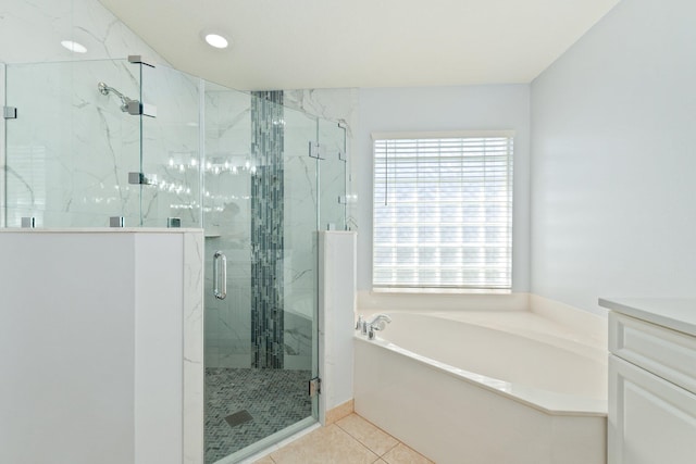 bathroom with vanity, tile patterned flooring, and plus walk in shower