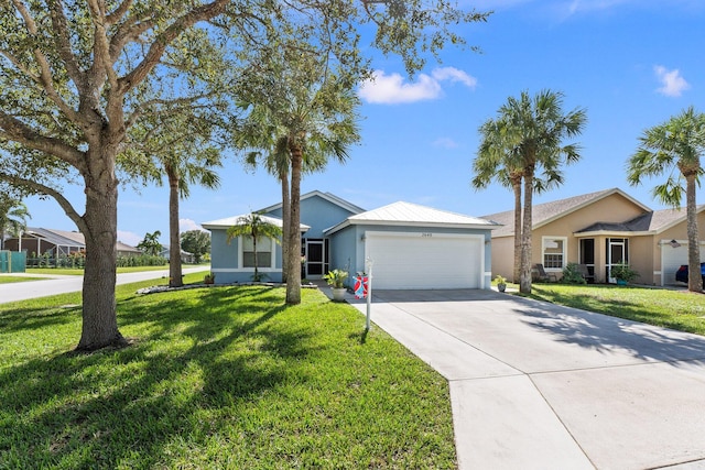 single story home featuring a garage and a front lawn