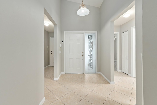 tiled foyer entrance with high vaulted ceiling