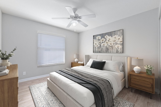 bedroom with light hardwood / wood-style floors and ceiling fan