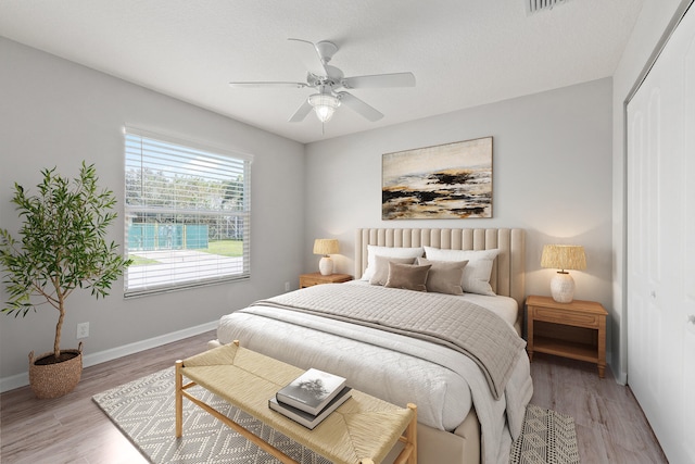 bedroom with a closet, ceiling fan, and hardwood / wood-style floors