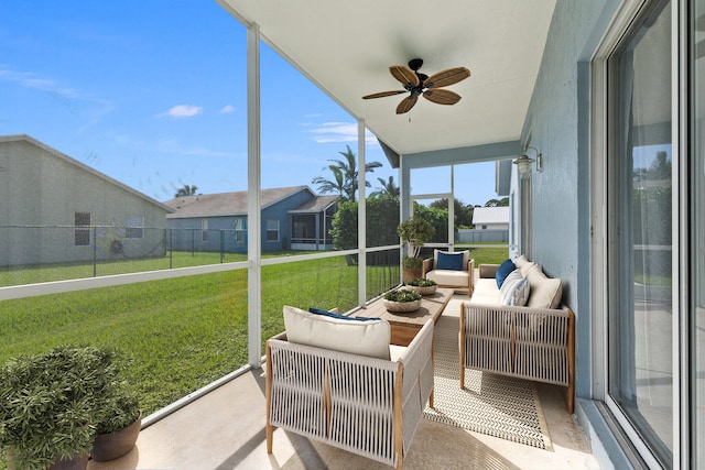 sunroom featuring ceiling fan