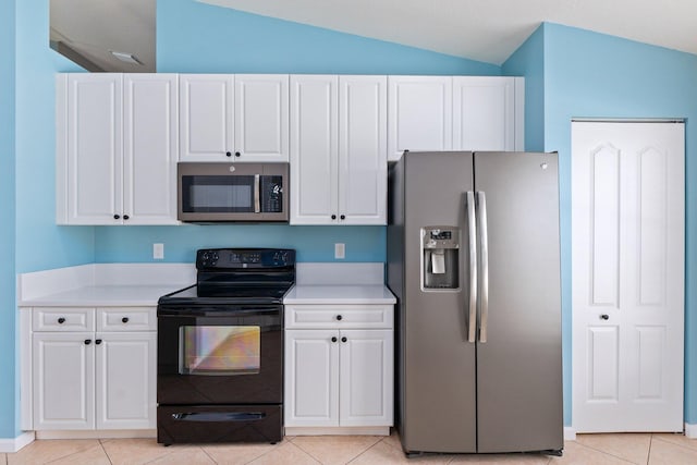 kitchen with white cabinets, stainless steel appliances, and vaulted ceiling