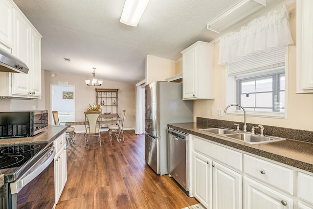 kitchen with lofted ceiling, white cabinets, dark hardwood / wood-style floors, sink, and stainless steel appliances