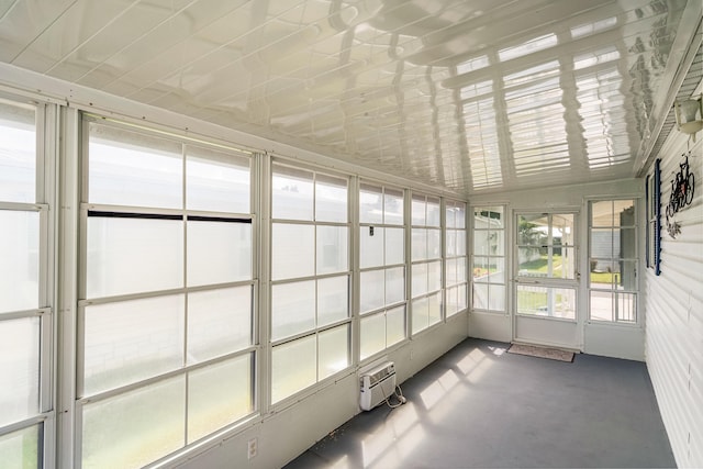 unfurnished sunroom with a wall mounted AC