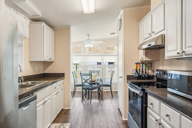 kitchen with white cabinetry, appliances with stainless steel finishes, a textured ceiling, and dark wood-type flooring