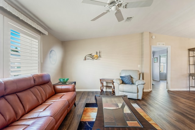 living room featuring lofted ceiling, dark wood-type flooring, and ceiling fan