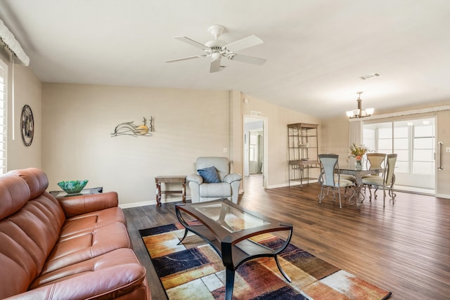 living room with lofted ceiling, dark hardwood / wood-style floors, and ceiling fan with notable chandelier