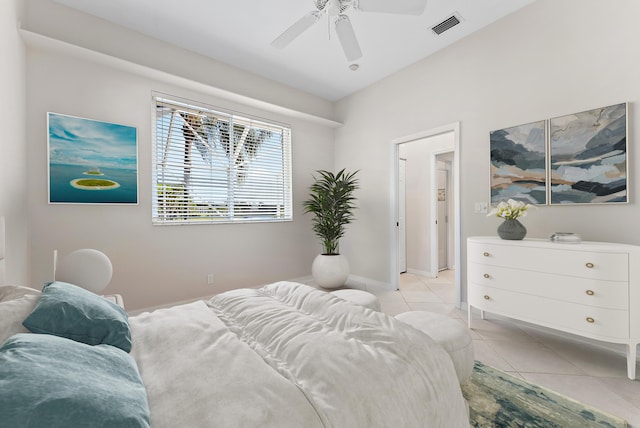 bedroom with baseboards, light tile patterned flooring, visible vents, and a ceiling fan