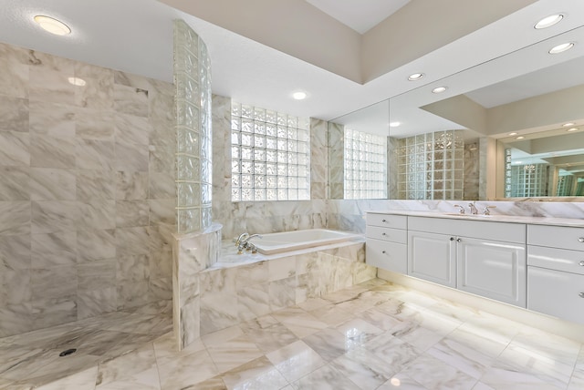 kitchen with a peninsula, white appliances, backsplash, and light brown cabinets