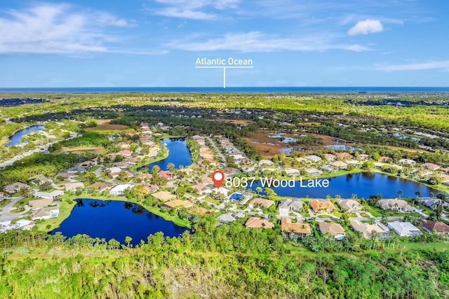 birds eye view of property featuring a water view and a residential view