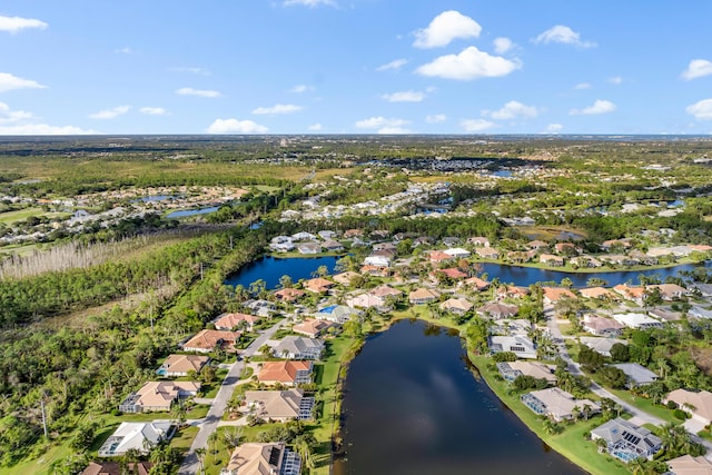 birds eye view of property featuring a water view and a residential view