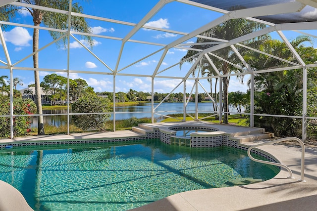 view of pool with a water view, glass enclosure, a pool with connected hot tub, and a patio