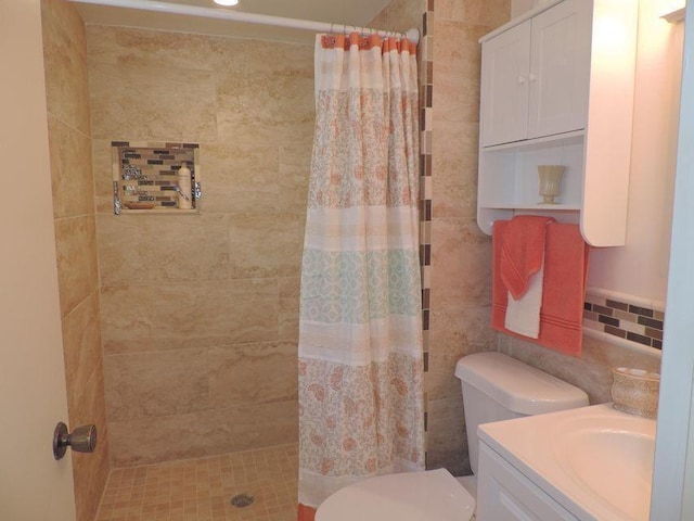 bathroom with toilet, a shower with curtain, vanity, and tile walls