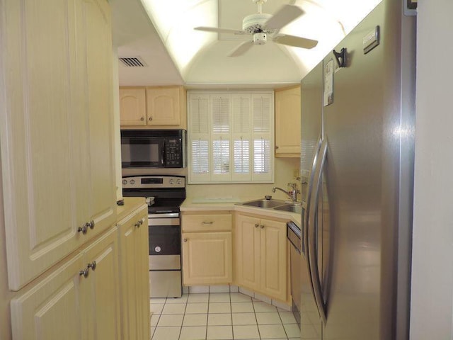 kitchen featuring sink, light tile patterned flooring, light brown cabinetry, appliances with stainless steel finishes, and ceiling fan