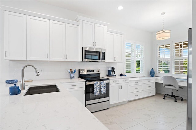 kitchen with decorative backsplash, white cabinets, a sink, appliances with stainless steel finishes, and marble finish floor
