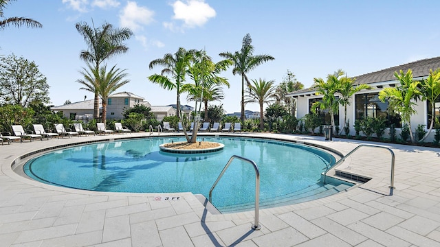community pool featuring a patio and fence
