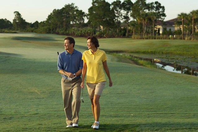view of home's community featuring a yard and view of golf course