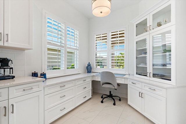 home office featuring marble finish floor and built in study area