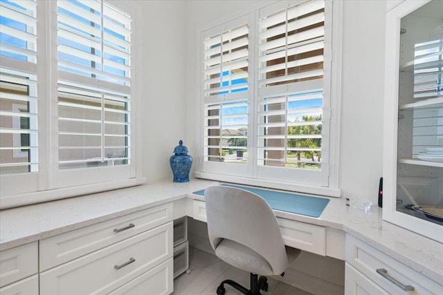 home office featuring built in desk and tile patterned floors