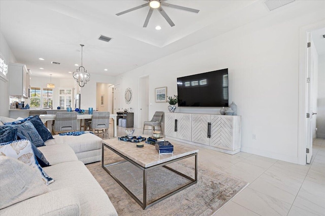 living room featuring recessed lighting, marble finish floor, ceiling fan with notable chandelier, baseboards, and visible vents