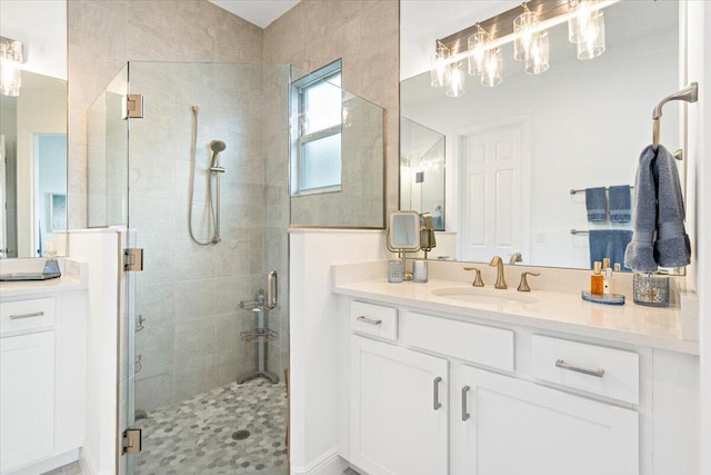 bathroom with a stall shower and vanity
