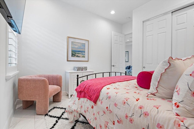 bedroom with baseboards, recessed lighting, a closet, and marble finish floor