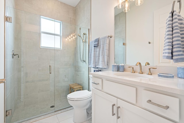full bathroom featuring toilet, tile patterned flooring, a shower stall, and vanity