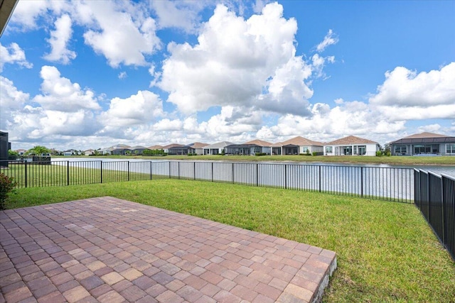 view of patio / terrace featuring a residential view, a water view, and a fenced backyard