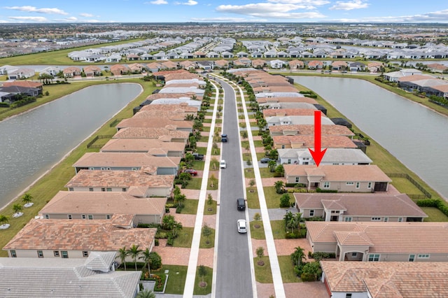 birds eye view of property with a residential view and a water view