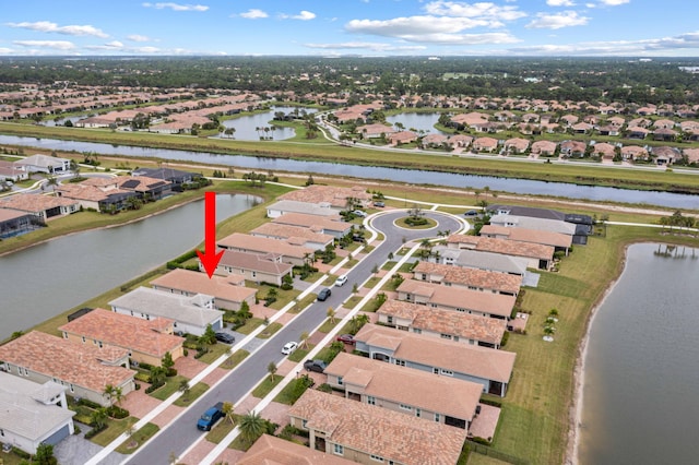 birds eye view of property with a residential view and a water view