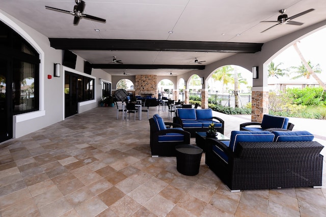 view of patio with outdoor dining space, ceiling fan, and an outdoor living space