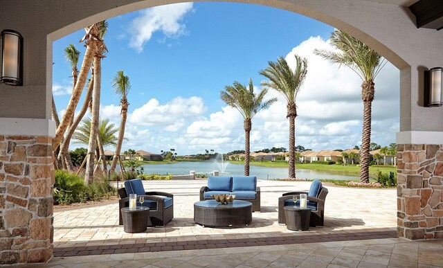 view of patio / terrace featuring a water view, outdoor lounge area, and a residential view