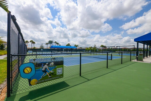 view of tennis court featuring fence