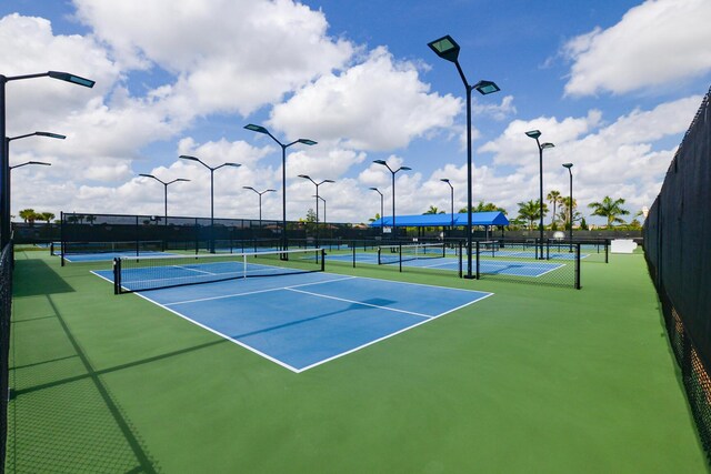 view of tennis court featuring fence