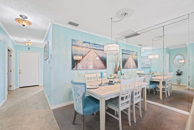 dining room featuring tile patterned floors, crown molding, and a textured ceiling