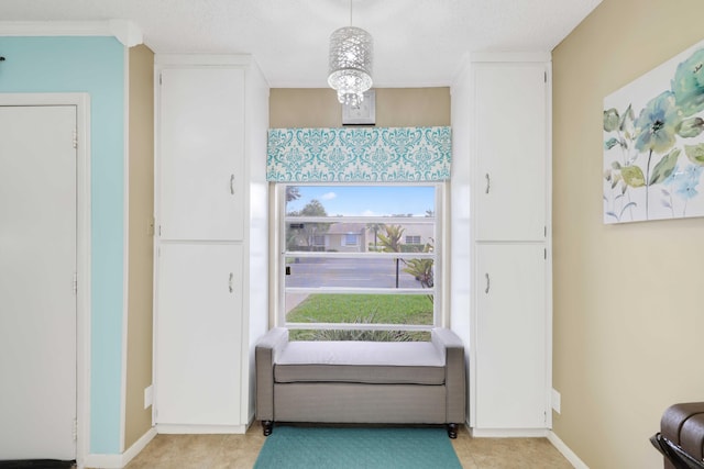 doorway to outside featuring light tile patterned floors and a textured ceiling