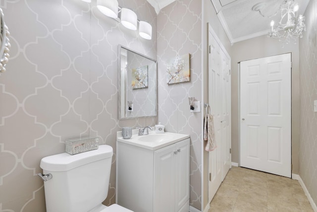 bathroom with an inviting chandelier, tile patterned flooring, toilet, vanity, and ornamental molding