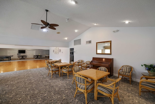 dining room featuring a textured ceiling, ceiling fan, and lofted ceiling