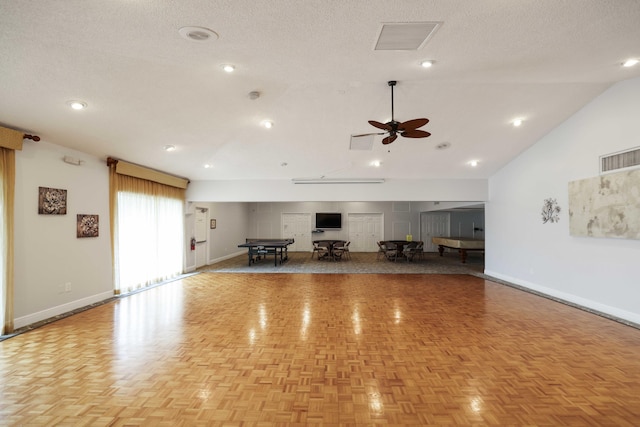 unfurnished living room featuring a textured ceiling, light parquet floors, ceiling fan, and lofted ceiling