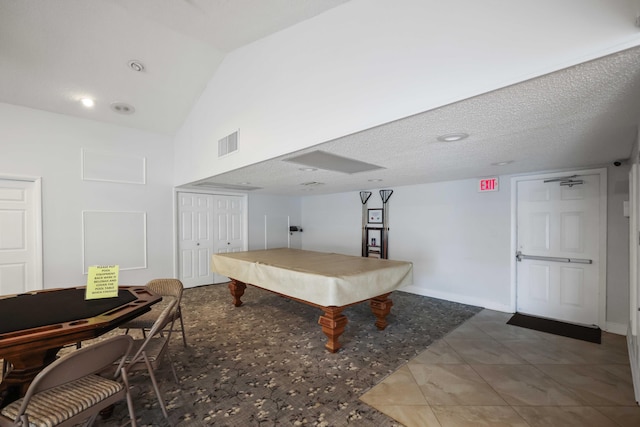 game room featuring tile patterned floors, lofted ceiling, a textured ceiling, and pool table