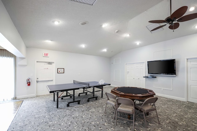 rec room with a textured ceiling, vaulted ceiling, and ceiling fan