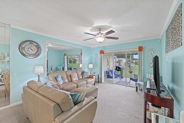 carpeted living room featuring a textured ceiling, plenty of natural light, ornamental molding, and ceiling fan