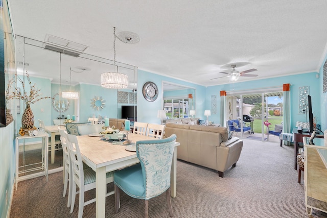 carpeted dining area with a textured ceiling, ceiling fan with notable chandelier, and crown molding