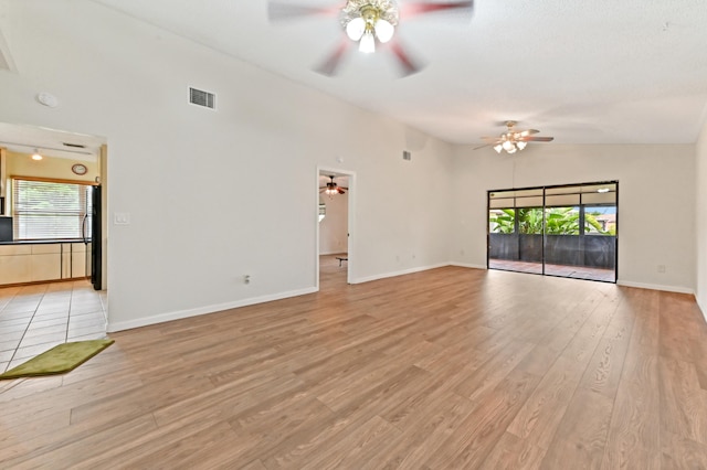 unfurnished living room with light hardwood / wood-style floors, high vaulted ceiling, and ceiling fan