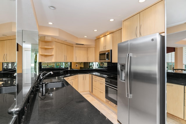 kitchen featuring light brown cabinetry, black appliances, sink, dark stone counters, and light tile patterned floors