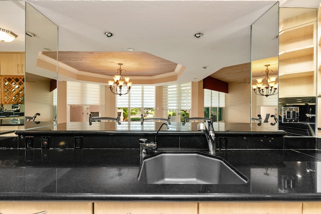 kitchen featuring sink and a raised ceiling