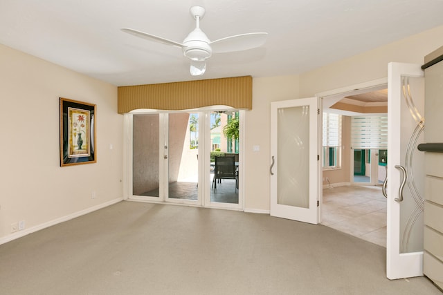 carpeted spare room with french doors and ceiling fan