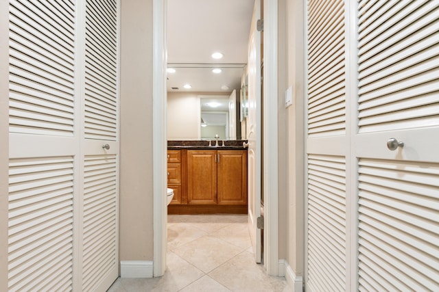 hall with light tile patterned flooring and sink